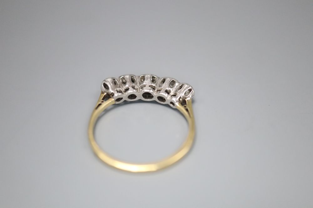 An 18ct and graduated illusion set five stone diamond half hoop ring, size L, gross 2.9 grams.